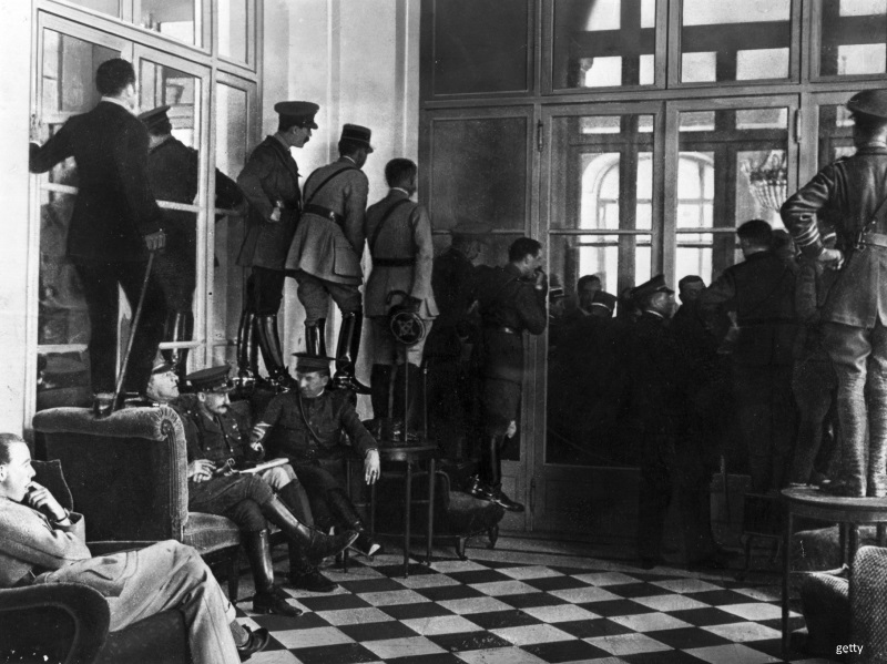 Soldiers watch the signing of the Treaty of Versailles.